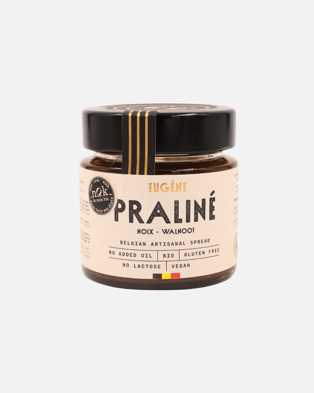Praliné Walnussbutter von Eugène Chocolatier in einem Glas mit beigem Etikett, schwarzem Deckel und goldener Verzierung.