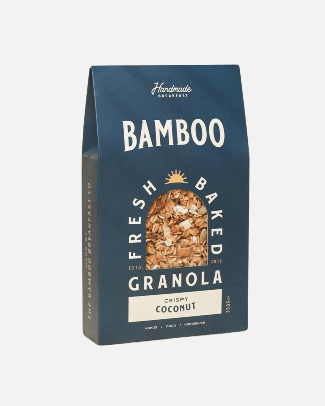 Eine Packung handgemachtes Granola mit knusprigen Kokosflocken von Bamboo Breakfast in einer blauen Verpackung.