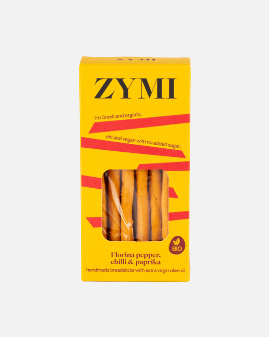 Gelbe Zymi-Verpackung von Bio-Brotstangen mit Florina-Pfeffer, Chili und Paprika, vor weißem Hintergrund.